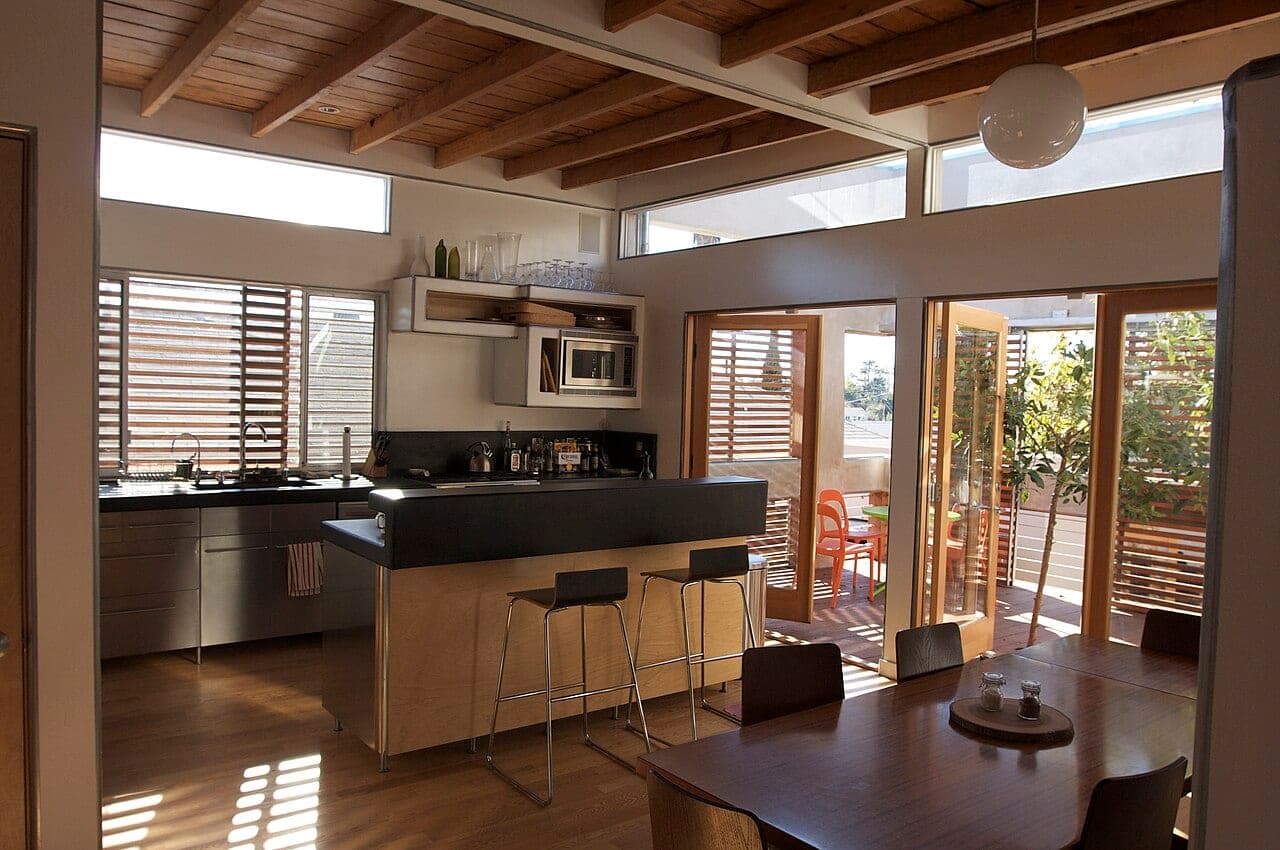 Kitchen opening to a leafy garden